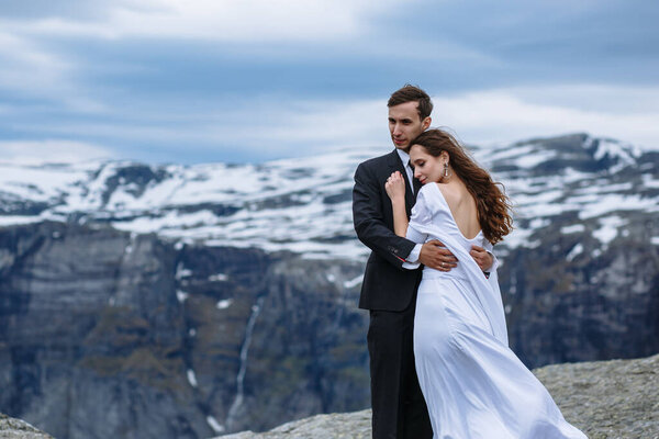 Bride and groom hugging high in the mountains