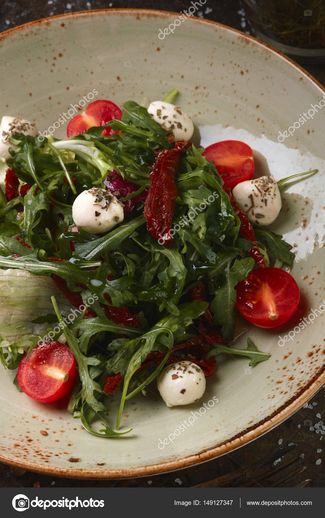 Salad with caprese and sundried tomatoes Stock Photo by ©Podraboty
