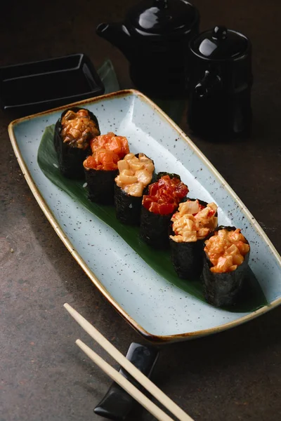 Sushi-Rolle mit Fisch in einem schönen blauen Teller. — Stockfoto