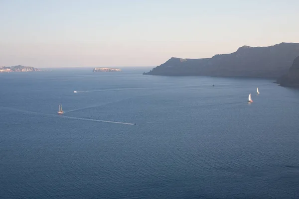 Santorini, Greece: boat on water against the background of rocks