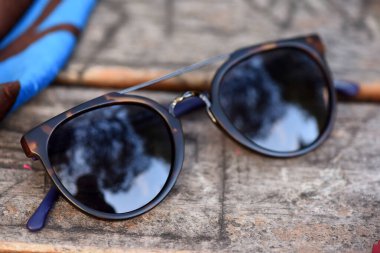 Güneş gözlüğü gözlükleri, doğal park alanında, ahşap masada.