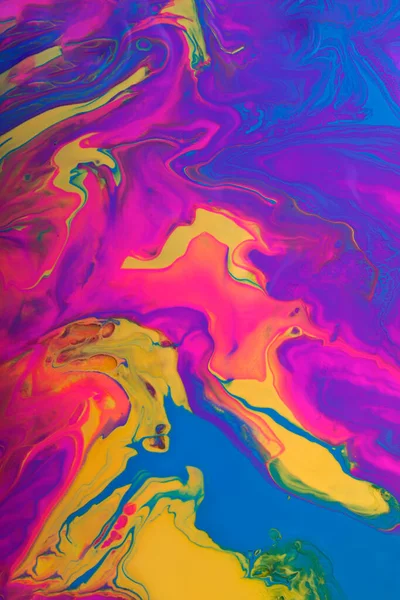 Colorful marble background.Mixed polishes-yellow,pink,blue and purple.Colorful marble background.Beautiful stains of liquid nail polish,fluid art technique.Pour painting technique.Vertical banner. — Stock Photo, Image