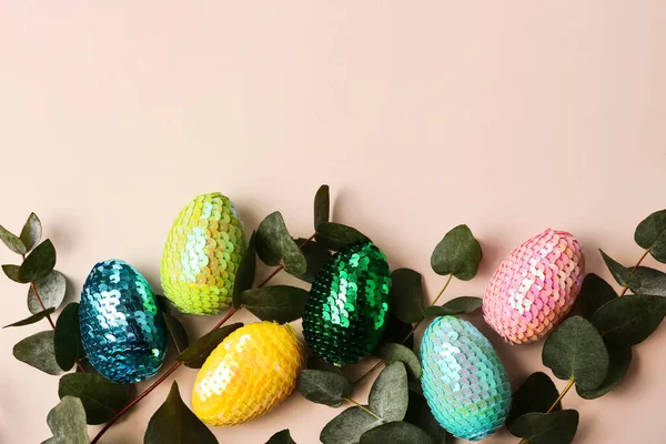 Colorate uova di Pasqua lucide witih foglie di eucalipto naturale.Trendy sfondo pastello. Copia spazio per testo o design . — Foto Stock