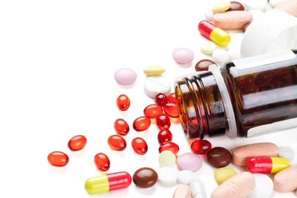 Red capsules and pills. — Stock Photo, Image