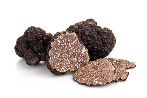 Black truffles and oak leaves. — Stock Photo, Image