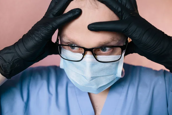 The doctor in surgical mask, glasses and glows thinking, in shocked. Nervous. Doctor worried, have a problem. Doctor in panic.