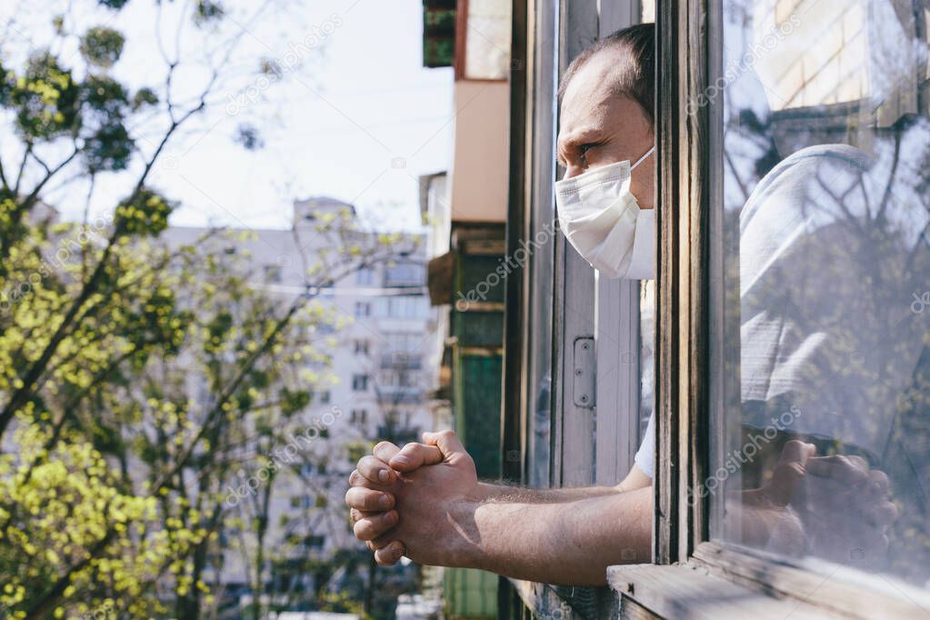 A man in protective mask on the balcony. Pandemic coronavirus 2020. Quarantine.Virus concept. Epidemic infection. 
