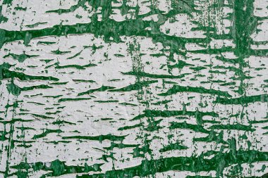 Eski ve paslanmış beyaz ve yeşil boyanmış metalik yüzeyin minimalist tek merkezli arka planı