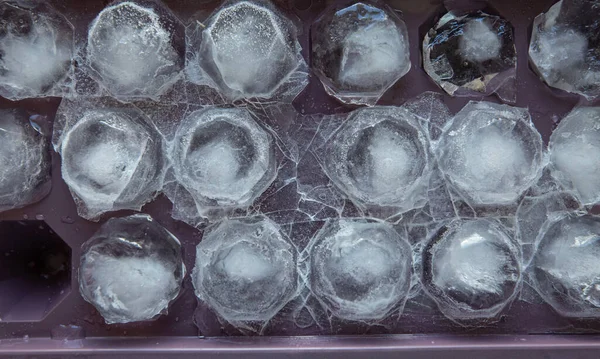 ice tray with pieces of ice in the form of rubies, closeup