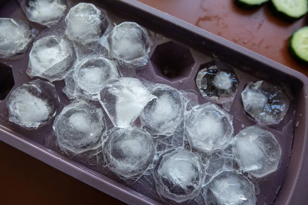 ice tray with pieces of ice in the form of rubies, closeup