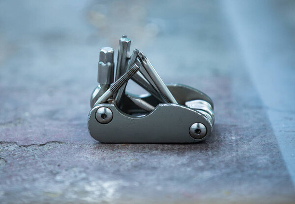 isolated metal chrome bicycle tools, close up bokeh effect