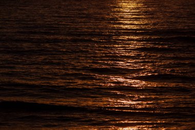 Gün batımında dalgalı deniz, turuncu ve kırmızı soyut doku