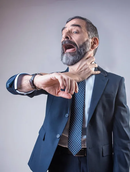 Wristwatch choking a senior business man — Stock Photo, Image