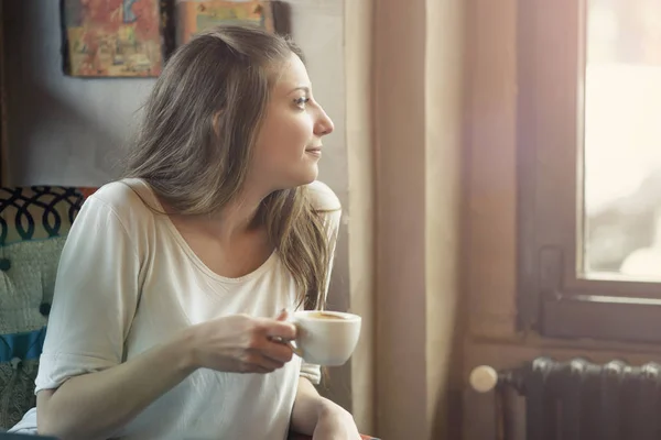 Happy young woman in a coffee shop Royalty Free Stock Images