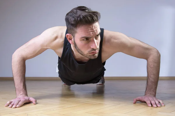 Fitness man doing push ups on a floor