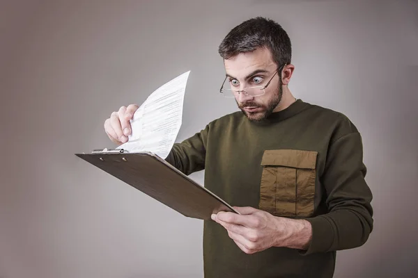 Young man shocked with his finance reports — Stock Photo, Image