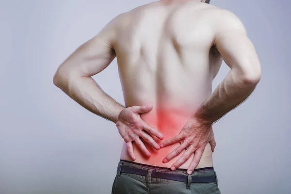 Lower back pain for a young man — Stock Photo, Image