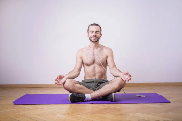 Shirtless man meditating
