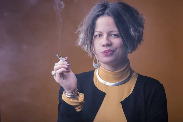 Шикарная стильная женщина курит — стоковое фото