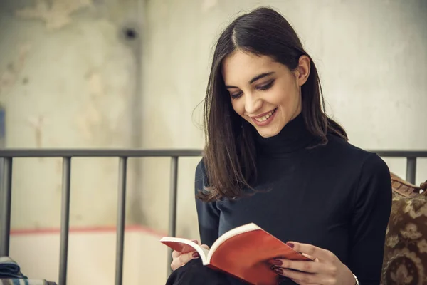 Mladá studentka s knihou v kavárně — Stock fotografie