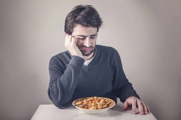 Young man is not hungry — Stock Photo, Image