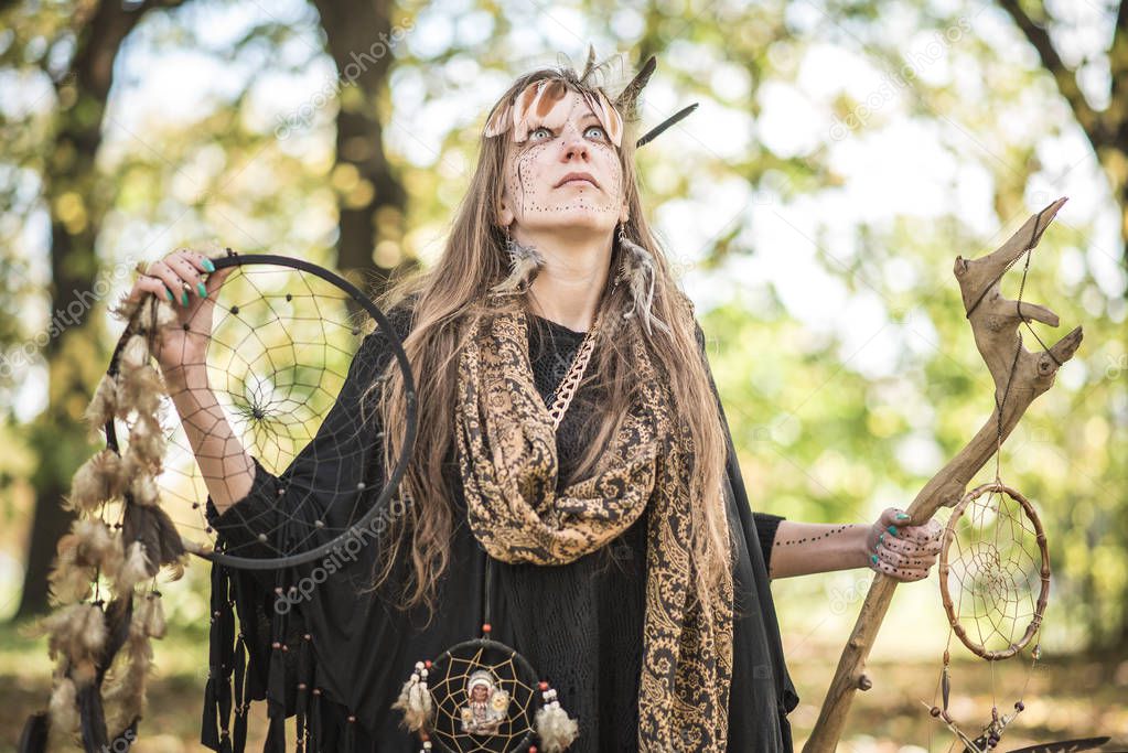 Shaman tribal woman casting ritual magic in nature