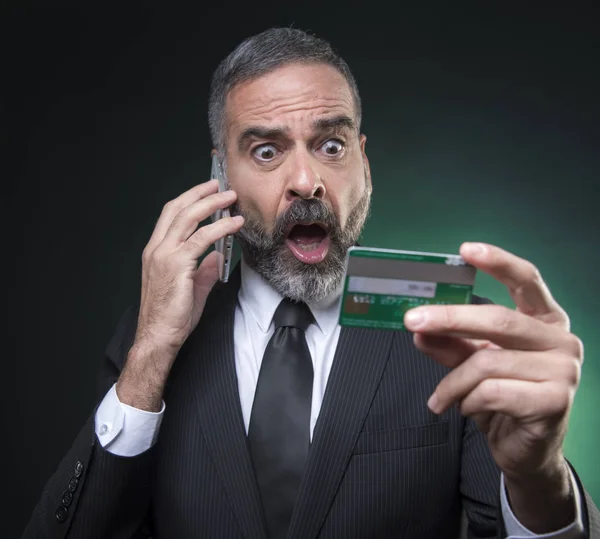 クレジットカード残高に全くショックを受けた上級ビジネスマン 携帯電話で銀行員と口論 — ストック写真