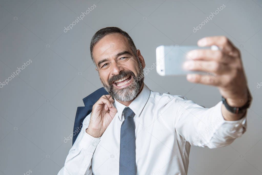 Selfie time, cheerful senior business man