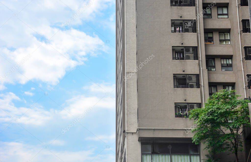 old vintage brownstone apartment building corner with blue sky background, Taipei, Taiwan