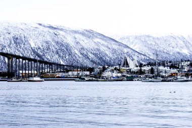 Iconic cathedral and bridge in the Tromso fjord in the northern Norway clipart