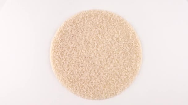 円状の形をした白い米が回転し — ストック動画