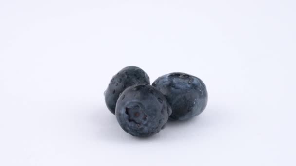 Three Blueberries Berries Quickly Rotates — Stock Video