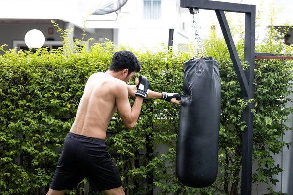 The man hit to bag on boxing training, he has target for fightin