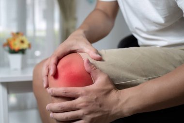 Koltukta oturan adam diz ağrısından muzdarip. Acı alanında boya rengi.