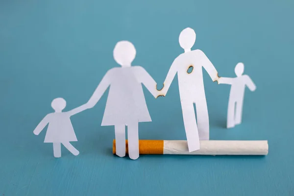 Paper cut of family destroyed by cigarettes. Drugs destroying family concept. Quit smoking for life on World no Tobacco day concept. World no tobacco day. Copy space for advertisers.