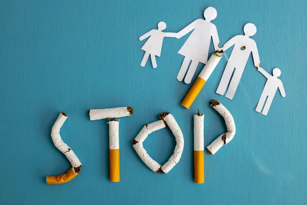 Paper cut of family destroyed by cigarettes. Drugs destroying family concept. Quit smoking for life on World no Tobacco day concept. World no tobacco day. Copy space for advertisers.