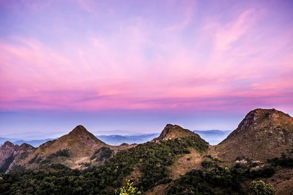 three mountain with purple sky