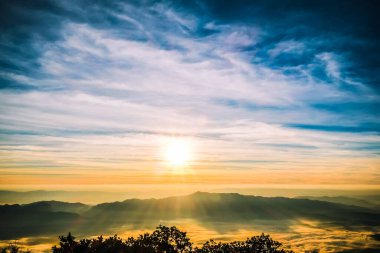 Sabah bulutsuz gökyüzü ve dağın tepesinde güneş