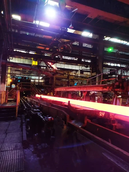 High temperature steel hardening in an industrial furnace in a pipe mill workshop. metallurgical industry, steel production, hot rolling mill