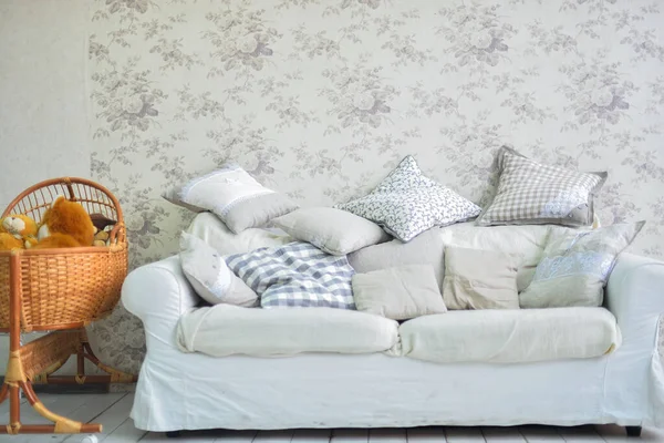 bright interior in provence style - bright sofa and bright pillows