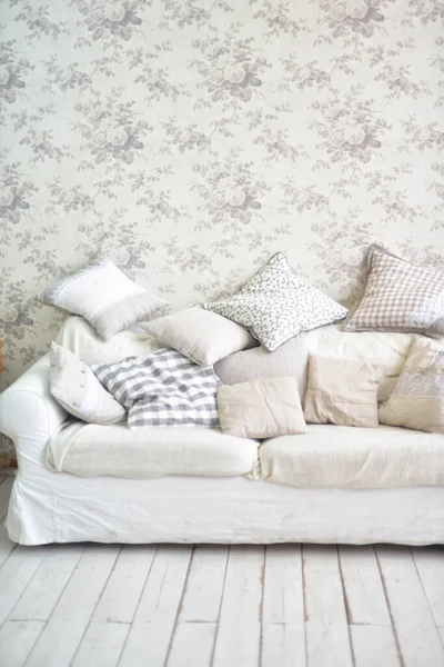 bright interior in provence style - bright sofa and bright pillows