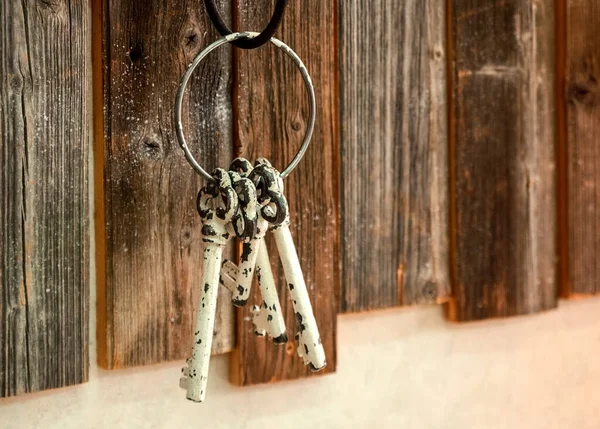 The key hangs on a hook on a wooden wall. Provence Interior Style