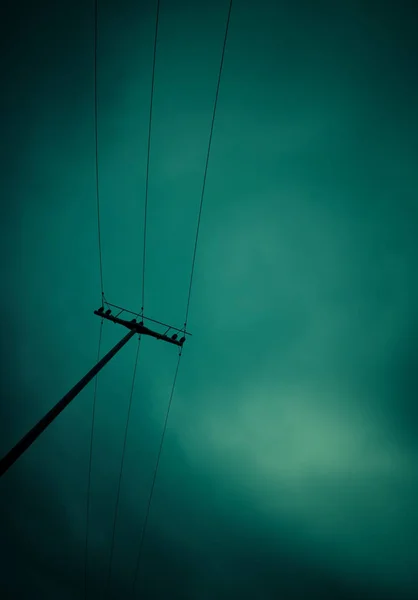 Power pylon in front of a green sky — Stock Photo, Image