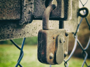 Old rusty lock on a fence