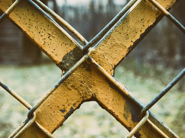 Yellow X at a fence — Stock Photo, Image