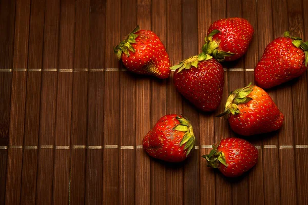 red strawberries on a textured background, top view, close-up