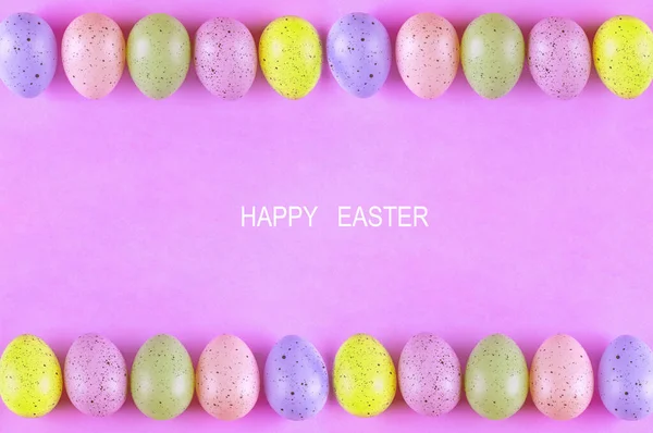 Easter multi-colored eggs on a pink background, Beautiful bright background.Place for text