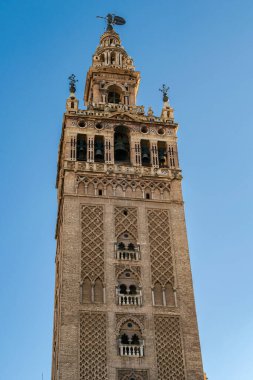 Gün batımında Sevilla 'nın Katedrali' nin La Giralda Çan Kulesi 'nde, arkasında güneş vardı. UNESCO Dünya Mirası Alanı Endülüs, İspanya.