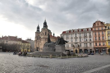 Prag, Çek Cumhuriyeti-17 Mart 2020: Jan Hus heykeli eski kasaba meydanında, Aziz Nicolas Kilisesi arka planda