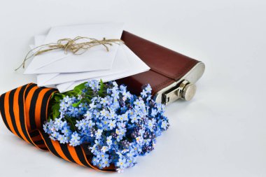 May 9th flower card, St. George ribbon, letters, flask on a blue background. empty space for text. clipart
